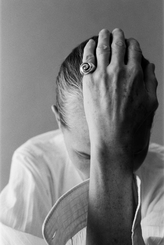 women with hand on head b&w with ring on finger