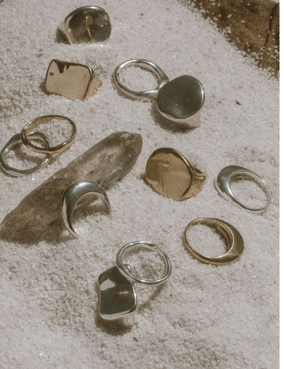 rings displayed on sand