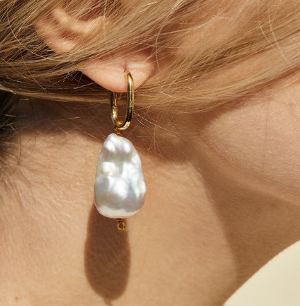 large pearl earing on woman